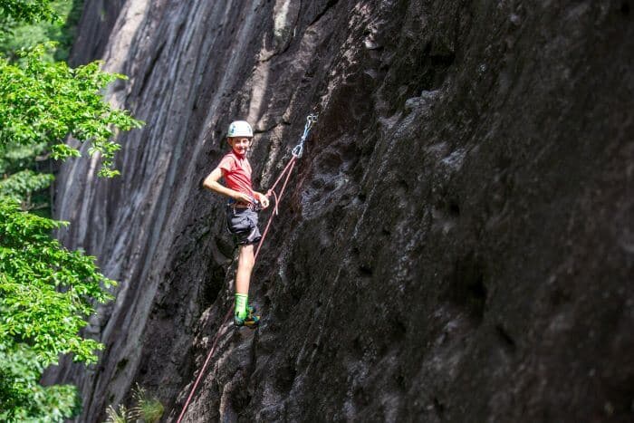 Young climber climbs at Cedar Rock, North Carolina
